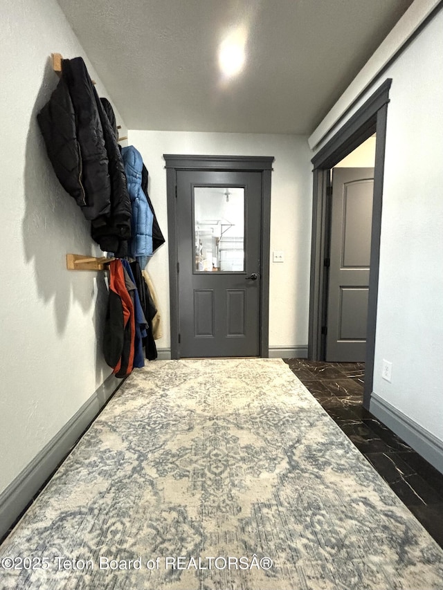 125 Wagon Rut Ln, Auburn, WY 83111 - entryway with baseboards and dark marble finish flooring