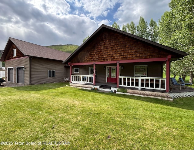 125 Wagon Rut Ln, Auburn, WY 83111 - rustic home with a porch, a garage, a front lawn, and a shingled roof