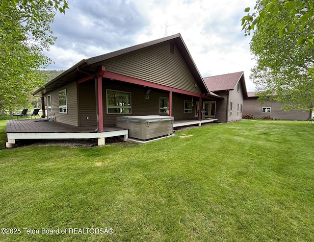 125 Wagon Rut Ln, Auburn, WY 83111 - back of property featuring a hot tub, a deck, and a lawn