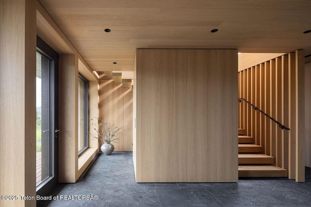 2205 W Pemmican Rd, Jackson, WY 83001 - hallway with healthy amount of natural light, stairway, and wood ceiling