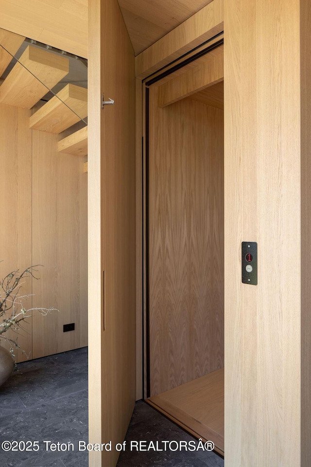 2205 W Pemmican Rd, Jackson, WY 83001 - hallway featuring wood walls and elevator