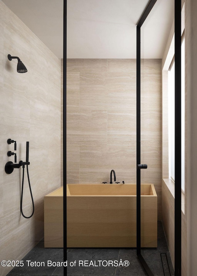 2205 W Pemmican Rd, Jackson, WY 83001 - full bath featuring tile walls, a tile shower, and a bath