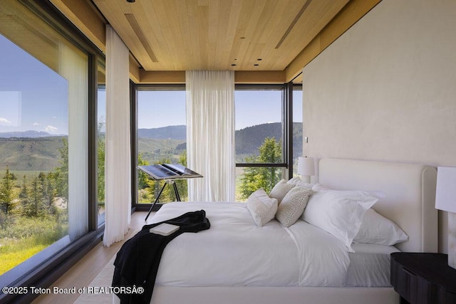 2205 W Pemmican Rd, Jackson, WY 83001 - bedroom featuring wooden ceiling, a mountain view, and wood finished floors