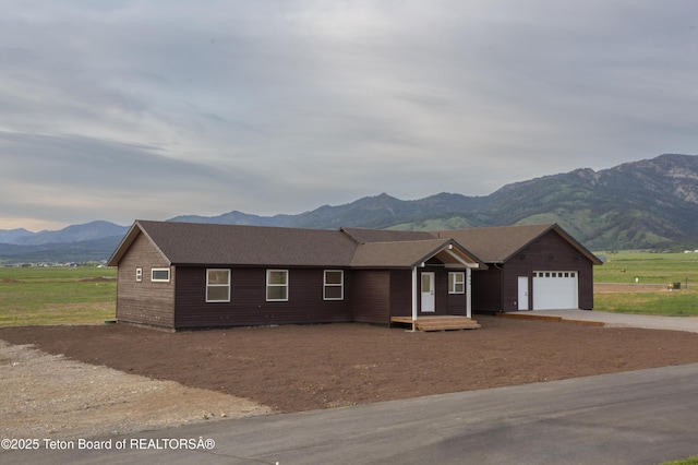 969 Caribou Peak Loop, Etna, WY 83118 - ranch-style house with an attached garage, a mountain view, and concrete driveway