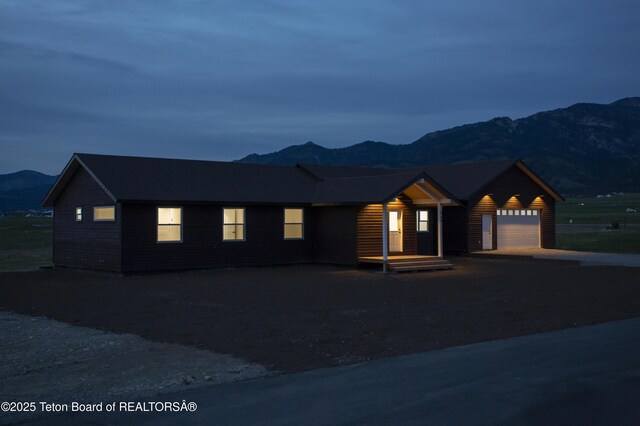 969 Caribou Peak Loop, Etna, WY 83118 - view of front of house with a mountain view, an attached garage, and driveway