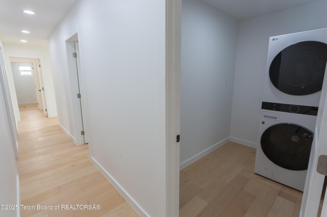 969 Caribou Peak Loop, Etna, WY 83118 - washroom featuring stacked washer / dryer, light wood-type flooring, and recessed lighting