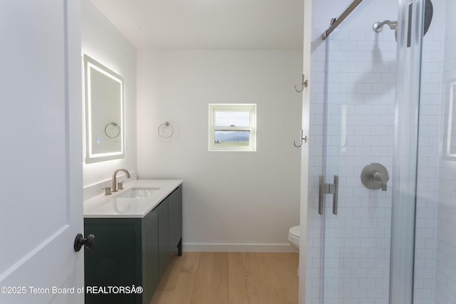 969 Caribou Peak Loop, Etna, WY 83118 - full bath featuring wood finished floors, a shower stall, and vanity