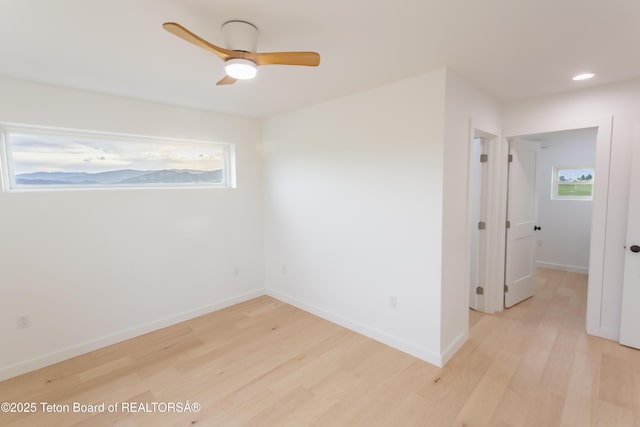 969 Caribou Peak Loop, Etna, WY 83118 - spare room featuring light wood-style floors, healthy amount of natural light, a ceiling fan, and recessed lighting