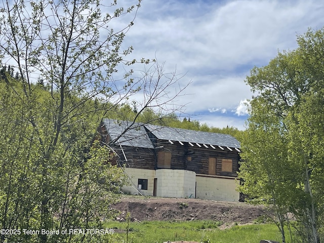777 Richardson Creek Rd, Afton, WY 83110 - view of side of property featuring roof with shingles and concrete block siding