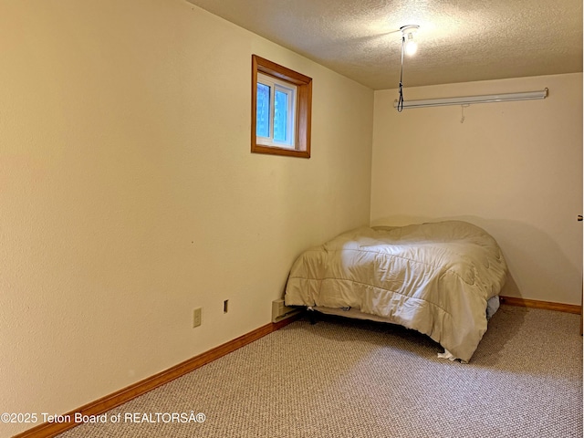 335 E Hansen Ave, Jackson, WY 83001 - bedroom featuring a textured ceiling, carpet floors, and baseboards
