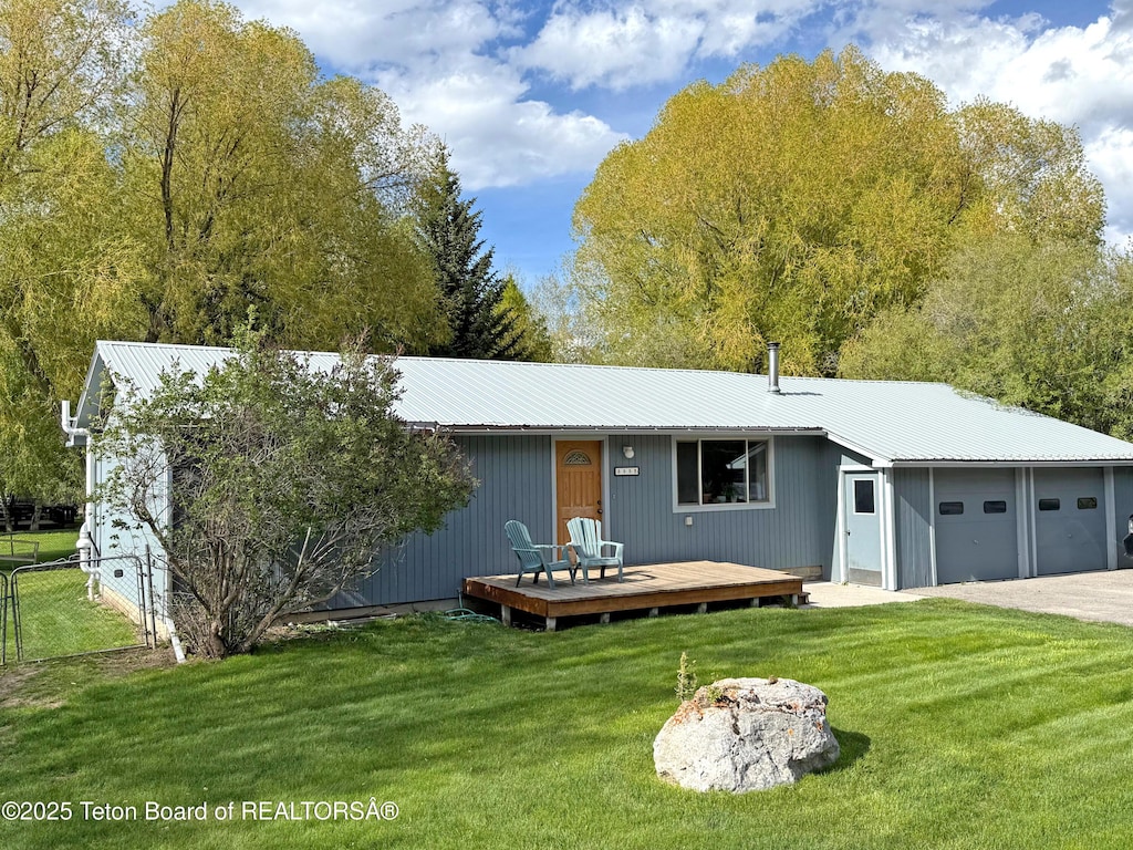 335 E Hansen Ave, Jackson, WY 83001 - back of house featuring a deck, metal roof, and a garage