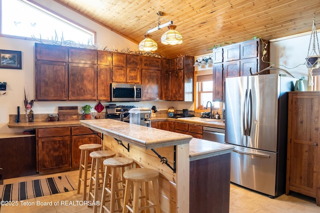 362 Snowmobile Ln, Daniel, WY 83115 - kitchen with appliances with stainless steel finishes, light countertops, wooden ceiling, vaulted ceiling, and light tile patterned flooring