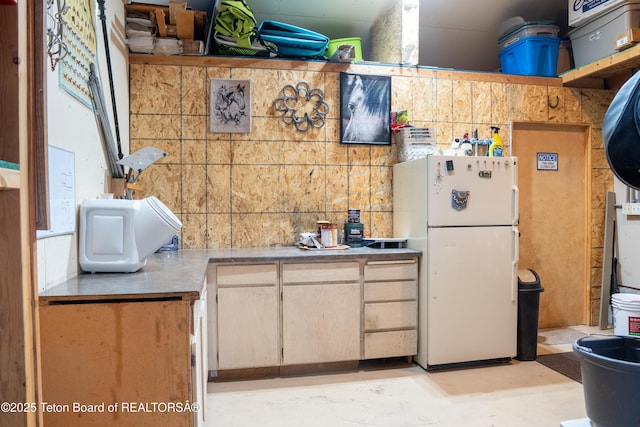 362 Snowmobile Ln, Daniel, WY 83115 - kitchen with freestanding refrigerator, concrete flooring, and light countertops