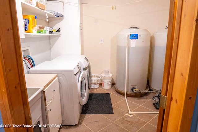 362 Snowmobile Ln, Daniel, WY 83115 - laundry area featuring washing machine and clothes dryer, cabinet space, and tile patterned floors