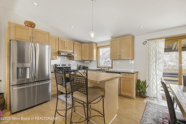 30 Stormy Cir, Jackson, WY 83001 - kitchen featuring butcher block counters, light brown cabinetry, stainless steel appliances, under cabinet range hood, and a sink