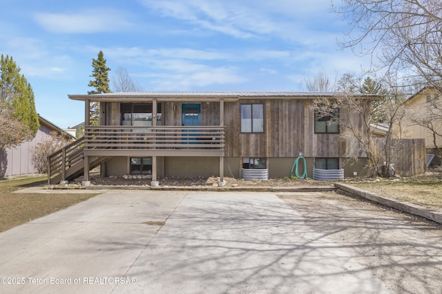 30 Stormy Cir, Jackson, WY 83001 - rustic home featuring metal roof, stairs, and covered porch