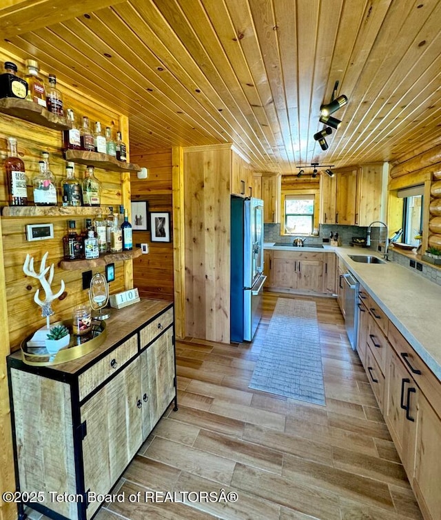 800 Dell Crk, Alpine, WY 83128 - kitchen with stainless steel appliances, wooden ceiling, a sink, light wood-style flooring, and light countertops