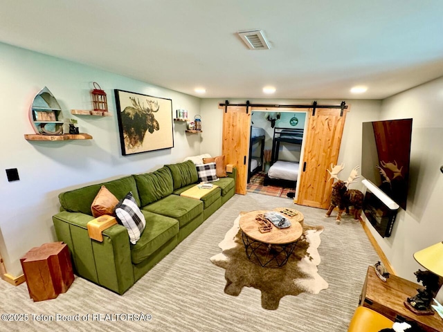 800 Dell Crk, Alpine, WY 83128 - carpeted living room featuring a barn door and recessed lighting