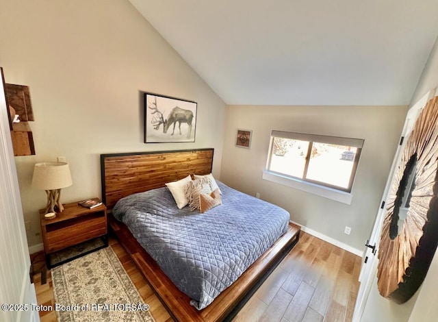 800 Dell Crk, Alpine, WY 83128 - bedroom featuring lofted ceiling, wood finished floors, and baseboards