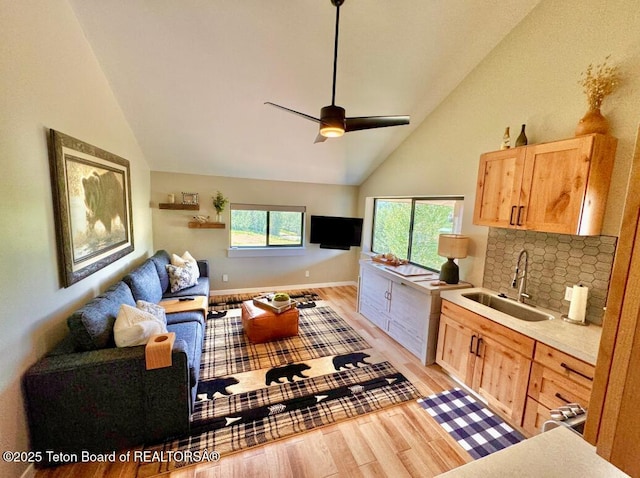 800 Dell Crk, Alpine, WY 83128 - living room with light wood finished floors, high vaulted ceiling, and a ceiling fan