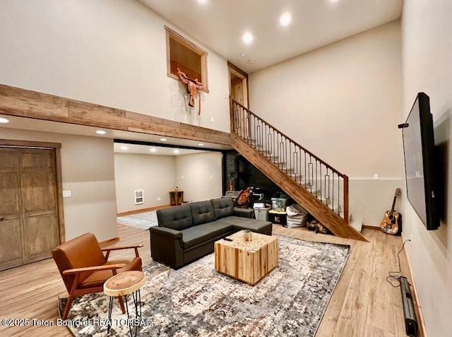 800 Dell Crk, Alpine, WY 83128 - living room featuring wood finished floors, a towering ceiling, stairs, recessed lighting, and baseboards