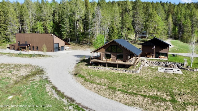 800 Dell Crk, Alpine, WY 83128 - exterior space featuring a forest view, driveway, an outdoor structure, and a garage