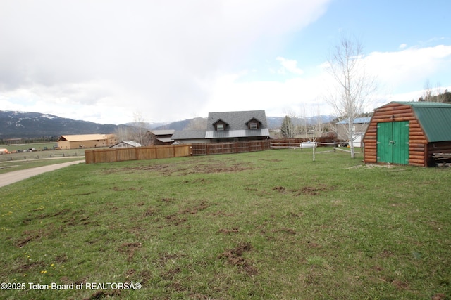 10 Foothill Blvd, Alpine, WY 83128 - view of yard featuring a mountain view, an outdoor structure, fence, and a storage unit