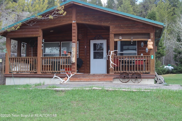10 Foothill Blvd, Alpine, WY 83128 - view of front of home featuring a porch and log veneer siding