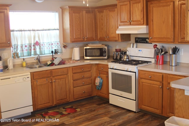 10 Foothill Blvd, Alpine, WY 83128 - kitchen featuring a sink, white appliances, dark wood finished floors, under cabinet range hood, and light countertops