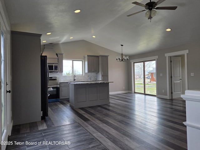 532 Palisade Trl, Driggs, ID 83422 - kitchen with a kitchen island, dark wood-style flooring, appliances with stainless steel finishes, vaulted ceiling, and ceiling fan with notable chandelier
