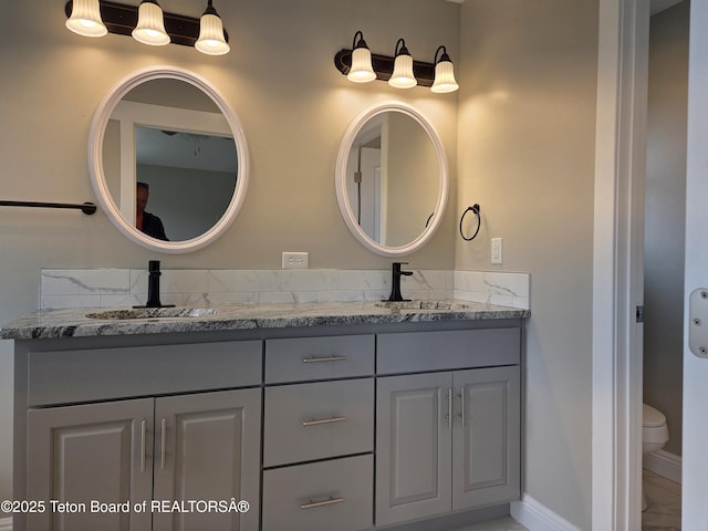 532 Palisade Trl, Driggs, ID 83422 - full bathroom with double vanity, toilet, a sink, and marble finish floor