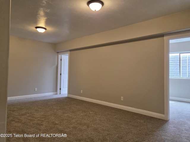 532 Palisade Trl, Driggs, ID 83422 - empty room featuring dark carpet and baseboards