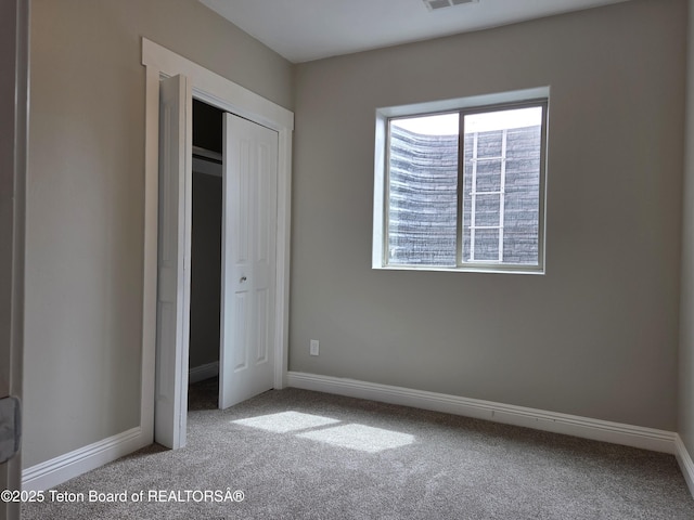 532 Palisade Trl, Driggs, ID 83422 - unfurnished bedroom featuring a closet, baseboards, carpet flooring, and visible vents