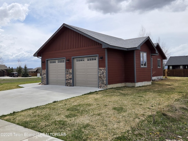 532 Palisade Trl, Driggs, ID 83422 - view of property exterior featuring a lawn, stone siding, and a garage