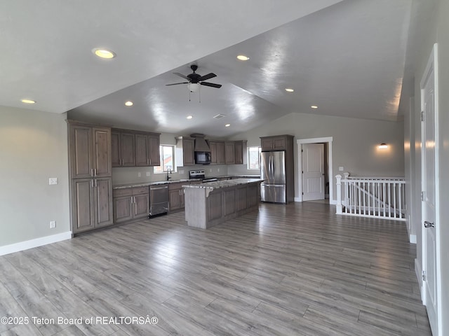 564 Palisade Trl, Driggs, ID 83422 - kitchen with a sink, stainless steel appliances, baseboards, a ceiling fan, and open floor plan