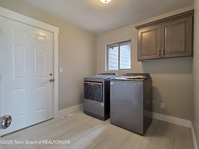 564 Palisade Trl, Driggs, ID 83422 - laundry area with baseboards, cabinet space, visible vents, and washing machine and clothes dryer