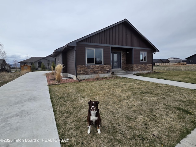 564 Palisade Trl, Driggs, ID 83422 - view of front of house with board and batten siding, stone siding, driveway, and a front yard