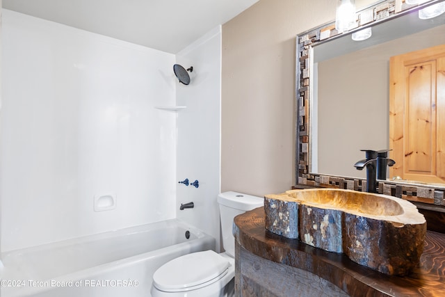 bathroom featuring shower / bathtub combination, toilet, and vanity
