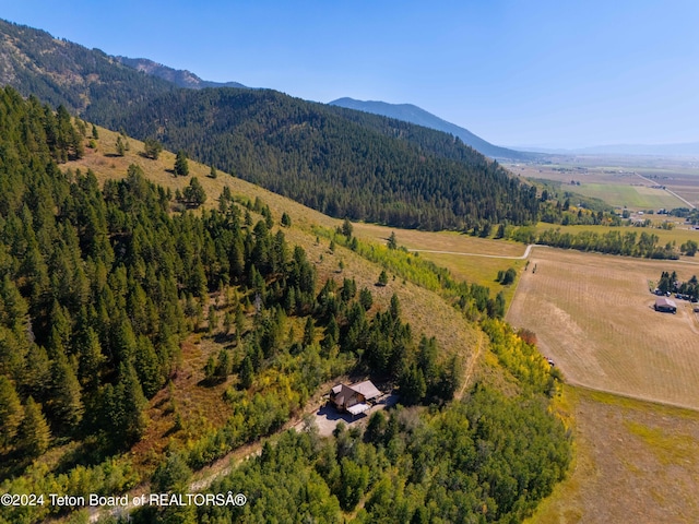 drone / aerial view featuring a forest view and a mountain view
