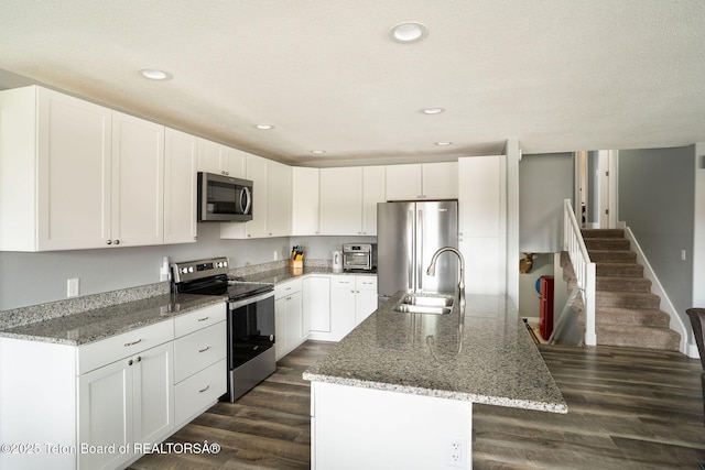 811 Jade St, Pinedale, WY 82941 - kitchen with appliances with stainless steel finishes, a sink, a kitchen island with sink, light stone counters, and recessed lighting