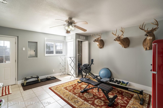 811 Jade St, Pinedale, WY 82941 - workout area with electric panel, ceiling fan, light tile patterned floors, baseboards, and a textured ceiling