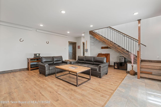 living area featuring stairs, light wood-style flooring, and recessed lighting