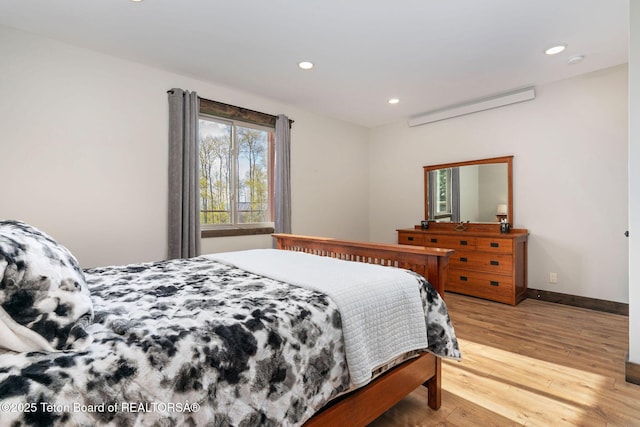 bedroom featuring recessed lighting, light wood-type flooring, and multiple windows