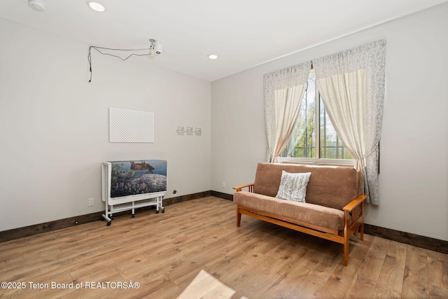 sitting room with baseboards, recessed lighting, and light wood-type flooring