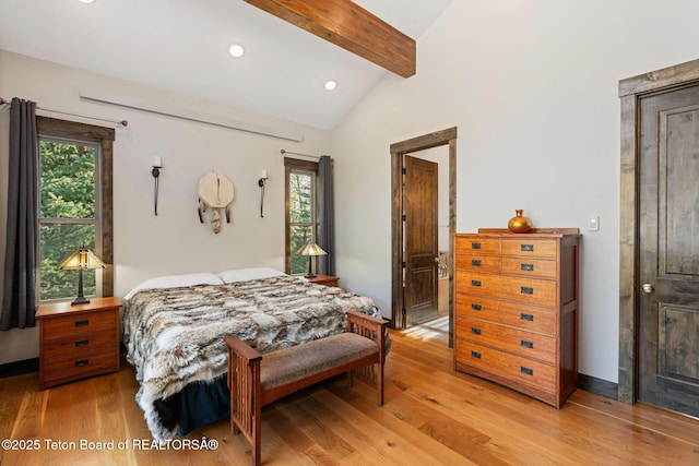 bedroom with recessed lighting, lofted ceiling with beams, multiple windows, and light wood-style floors