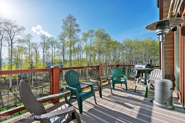 wooden terrace with a grill