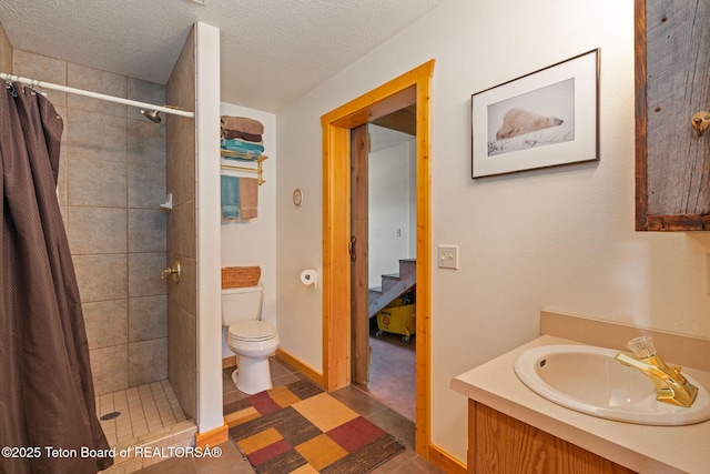 86 Hawks Rest Rd, Etna, WY 83118 - bathroom featuring toilet, vanity, a shower stall, a textured ceiling, and tile patterned floors