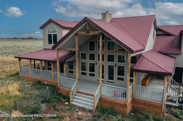 4 Beaver Ridge Rd, Daniel, WY 83115 - rear view of property featuring a chimney, a porch, and metal roof