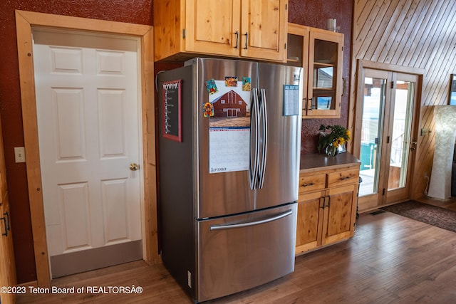 4 Beaver Ridge Rd, Daniel, WY 83115 - kitchen with visible vents, freestanding refrigerator, wood finished floors, and glass insert cabinets