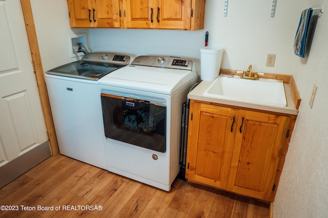 4 Beaver Ridge Rd, Daniel, WY 83115 - laundry room with a sink, light wood-type flooring, cabinet space, and washing machine and clothes dryer